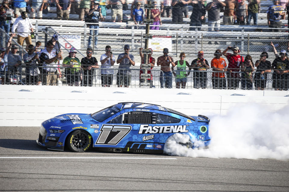 Chris Buescher does a burnout after winning a NASCAR Cup Series auto race, Sunday, July 30, 2023, in Richmond, Va. (AP Photo/Skip Rowland)