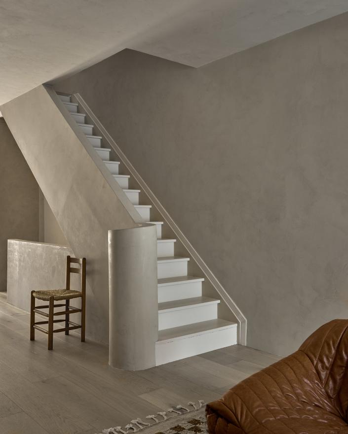 AFTER: Curved walls and a curved staircase were used to help create flow from one floor to the next.