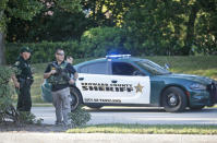 <p>Law enforcement officers block off a street following a shooting at Marjory Stoneman Douglas High School, Feb. 14, 2018, in Parkland, Fla. (Photo: Wilfredo Lee/AP) </p>