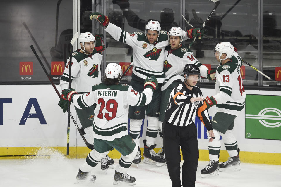 Minnesota Wild center Joel Eriksson Ek, second from right, celebrates his goal with Carson Soucy, Greg Pateryn, Jordan Greenway and Nick Bonino, from left, during the third period of the team's NHL hockey game against the Los Angeles Kings in Los Angeles, Saturday, Jan. 16, 2021. (AP Photo/Kelvin Kuo)