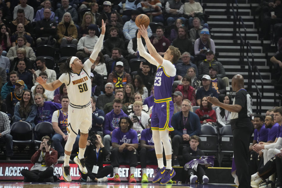 Utah Jazz forward Lauri Markkanen (23) shoots as Denver Nuggets forward Aaron Gordon (50) defends during the first half of an NBA basketball game Wednesday, Jan. 10, 2024, in Salt Lake City. (AP Photo/Rick Bowmer)