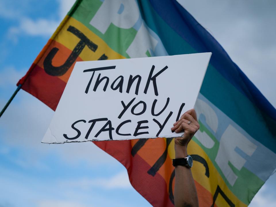 A supporter of Stacey Abrams holds a sign thanking her during a celebration of Democratic nominee Joe Biden's projected presidential win at Freedom Park on November 7, 2020 in Atlanta, Georgia