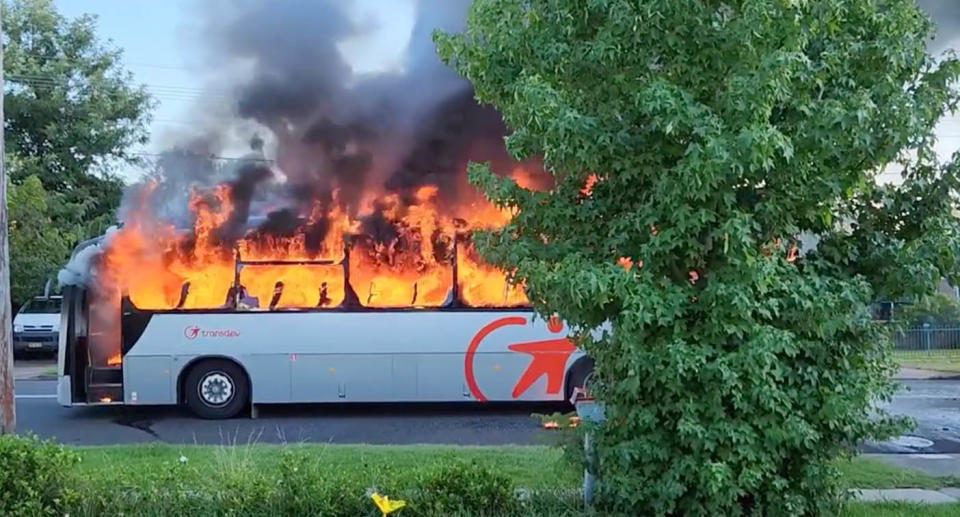 A photo of the school bus covered in flames.