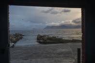 Weather moves on the small port of the seaside fishing village of Hawston, South Africa, April 27, 2023. Abalone here was abundant, yet the demand largely put the village and its traditional fishers out of business, or made them criminals overnight.(AP Photo/Jerome Delay)