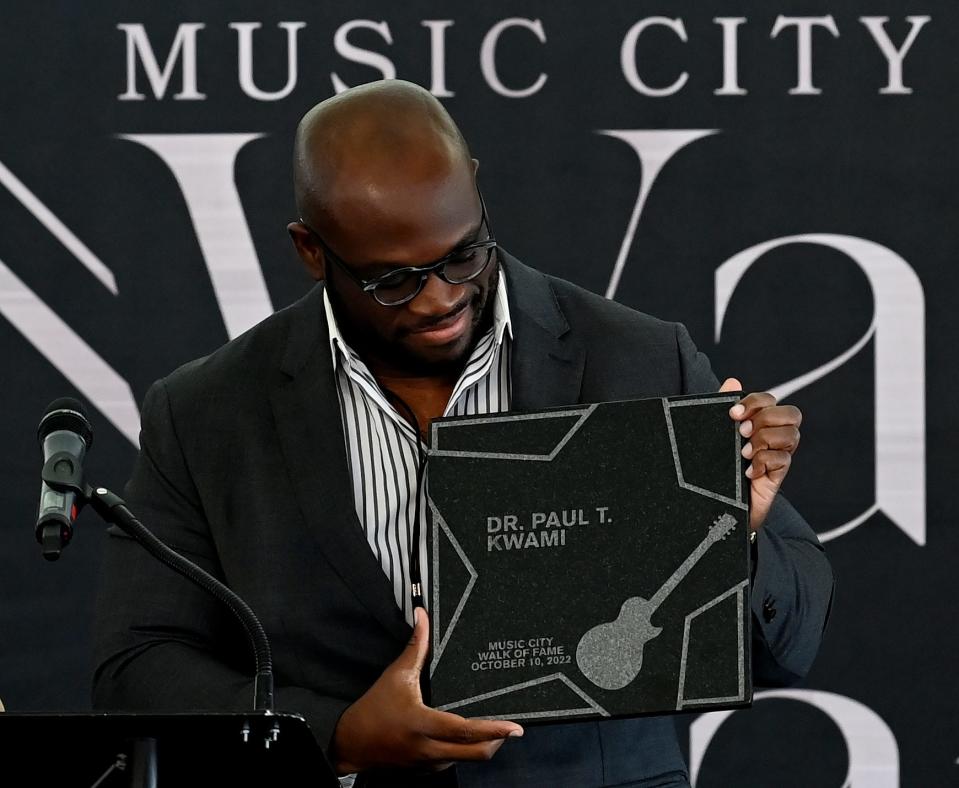 Delali Kwami holds a honorary plaque of his father, Dr. Paul T. Kwami, during the Music City Walk of Fame Induction Ceremony Monday, Oct. 10, 2022, in Nashville, Tenn. 