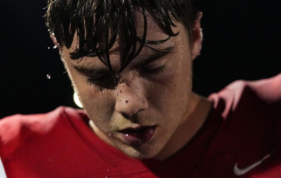 Water drips off of New Palestine Dragons offensive lineman Ian Moore (70) head on Friday, August 19, 2022 at New Palestine High School in New Palestine. New Palestine Dragons defeated the Westfield Shamrocks, 48-28.