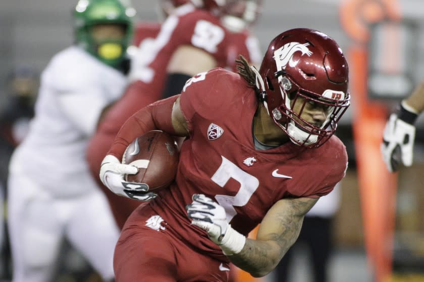 Washington State running back Deon McIntosh (3) carries the ball during the second half.