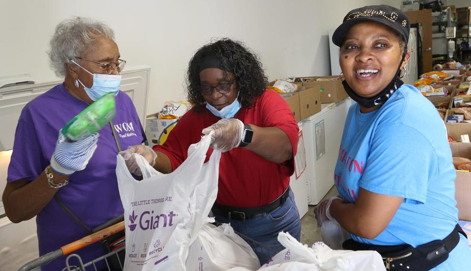 Winnie Keaton, Carolyn Barringer and Sylvia Wilson work to put together food bags Friday morning, May 20, 2022, at the Washington Outreach Ministry on Capernium Road near Cherryville.