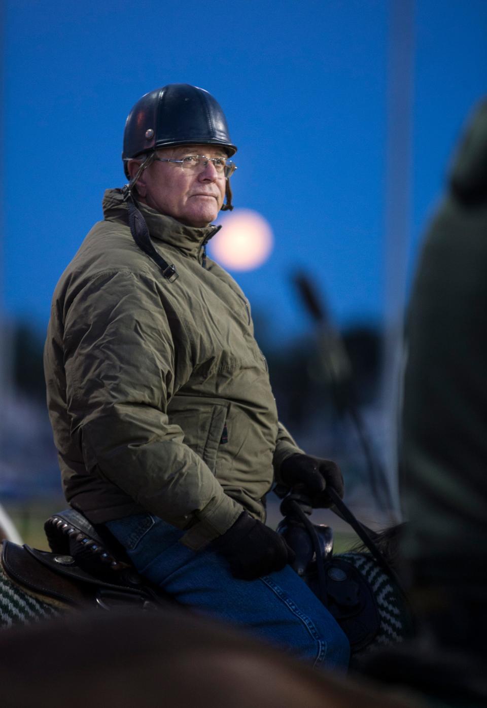Trainer Bill Mott watched with a full moon over his shoulder as his horses worked out at Churchill Downs on April 29, 2018.