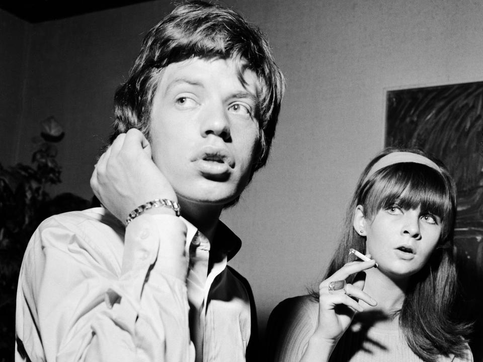 Black and white photo of Mick and Chrissie looking to the side with their mouths open surprised.