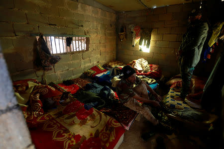 Popular Mobilisation Forces (PMF) fighters rest in al-Qaim, Iraq, near the border with Syria,,November 26, 2018. REUTERS/Alaa al-Marjani