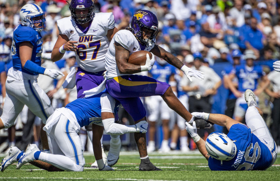 Northern Iowa running back Dom Williams (7) is tackled by Air Force safety Jayden Goodwin (16) and defensive lineman Peyton Zdroik (96) during an NCAA college football game Saturday Sept. 3, 2022, in Colorado Springs, Colo. (Parker Seibold/The Gazette via AP)