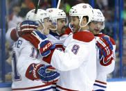 Montreal Canadiens center Tomas Plekanec, second from left, of the Czech Republic, celebrates with teammates, including Brendan Gallagher, left, Brandon Prust, second from right, and Andrei Markov, right, after scoring against the Tampa Bay Lightning during the first period of Game 1 of a first-round NHL hockey playoff series on Wednesday, April 16, 2014, in Tampa, Fla. (AP Photo/Chris O'Meara)