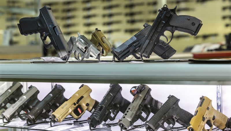 Guns on in a display case are pictured at Impact Guns in South Salt Lake on Wednesday, July 6, 2022. President Joe Biden released a new executive order Tuesday that he said will reduce gun violence.