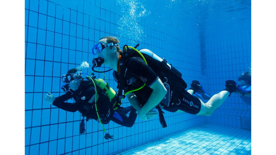 Prince William scuba diving in a swimming pool