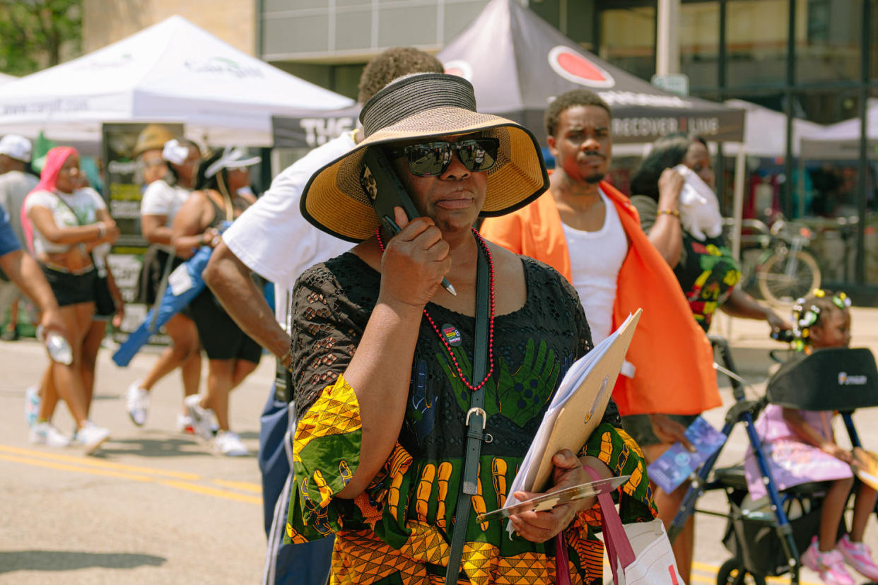 Kimberlee Foster takes a phone call while hold a clipboard (Mahdi Atif for NBC News)