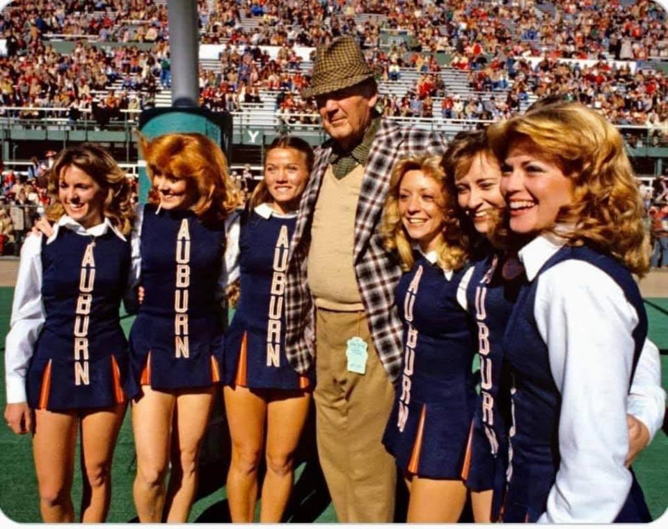 Crimson Tide coaching legend Bear Bryant posed with Auburn Tiger cheerleaders before the 1979 Iron Bowl. To his immediate right is Becky Sollie Clark, from Dothan.