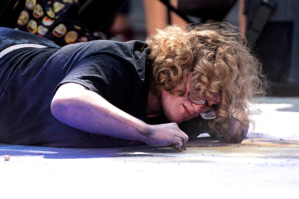 Forest Hill High School student Laura Phillips, 17, works on a chalk painting of her favorite singer Selena Quintanilla during the Lake Worth Beach annual Street Painting Festival Sunday February 26, 2023 in Lake Worth Beach. Though Phillips is legally blind, this is her second year participating in the event. 