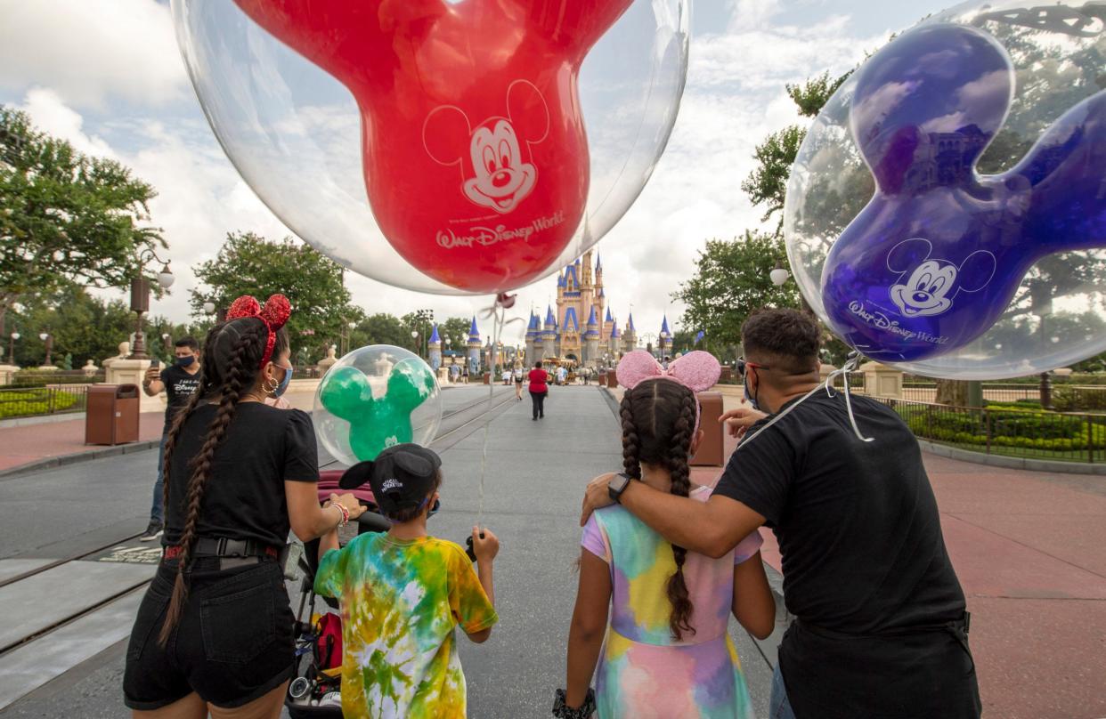 Guests walk down Main Street, U.S.A. at Disney World's Magic Kingdom.