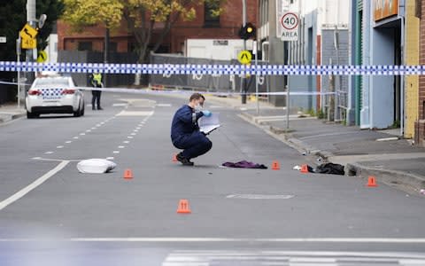 A Victoria Police personnel works at the scene of a multiple shooting outside Love Machine nightclub in Prahran, Melbourne - Credit: Reuters