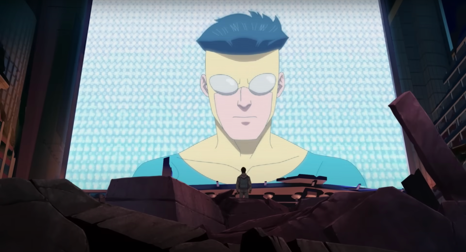 a still of the animated character mark, a young man with dark hair wearing a yellow and blue superhero suit and grey goggles, on a big screen in front of another person, from season 2 of the tv series invincible