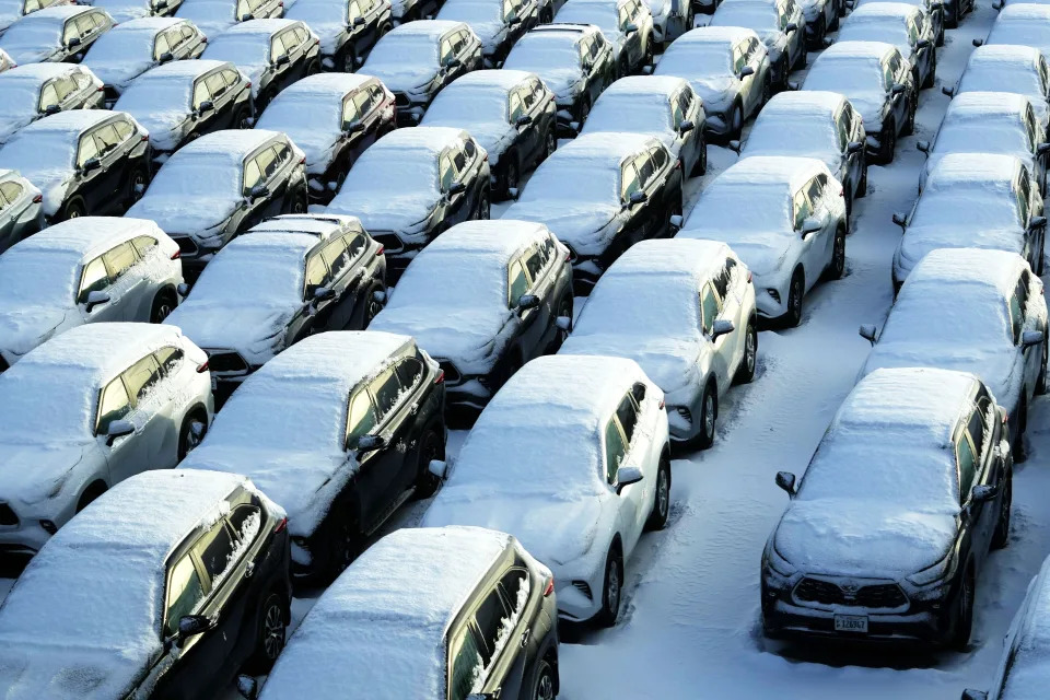 Snow covered vehicles sit in a rental car parking lot at the O'Hare International Airport in Chicago, Sunday, Jan. 14, 2024. Wind chill warning is in effect as dangerous cold conditions continue in the Chicago area. (AP Photo/Nam Y. Huh)