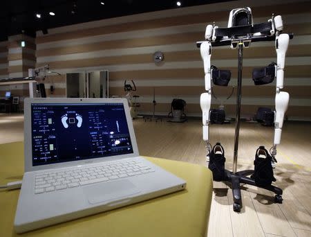 Japan's robot venture company Cyberdyne's Lower Limb Model HAL (Hybrid Assistive Limb) for welfare use is seen next to a laptop showing HAL monitor, which indicates signals of users including the center point of the balance, shift of the center point of the balance, and bioelectric potential level st the Cyberdyne studio in Tsukuba, north of Tokyo July 22, 2014. REUTERS/Yuya Shino