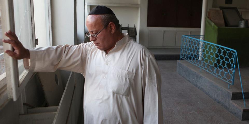 In this photo taken Saturday, Aug. 29, 2009, Zebulon Simentov, the last known Jew living in Afghanistan, closes the window to the synagogue he cares for in his Kabul home. Simentov is the caretaker and sole member of Afghanistan's only working synagogue.