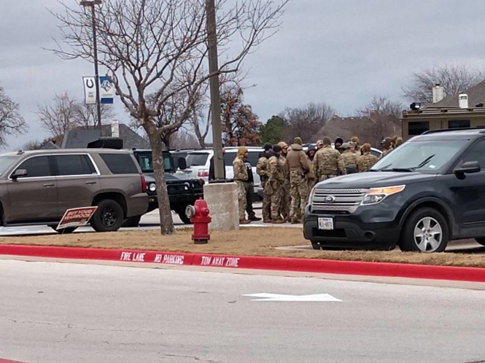 SWAT team members gathered at Colleyville Middle School, 1100 Bogart Drive, as police negotiated with a man who took hostages inside a nearby synagogue on Saturday, Jan. 15, 2022.