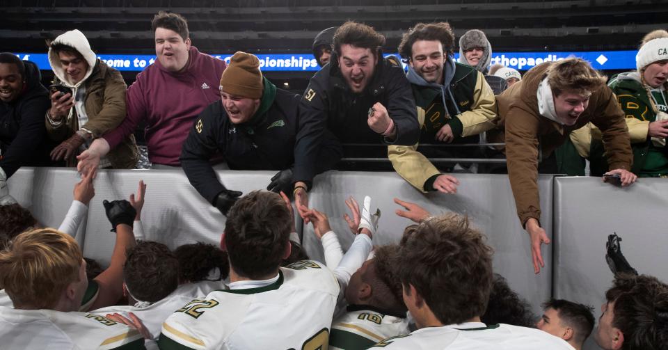 Red Bank Catholic's players celebrate with their fans after the Caseys 13-8 win over DePaul Friday night at MetLife Stadium