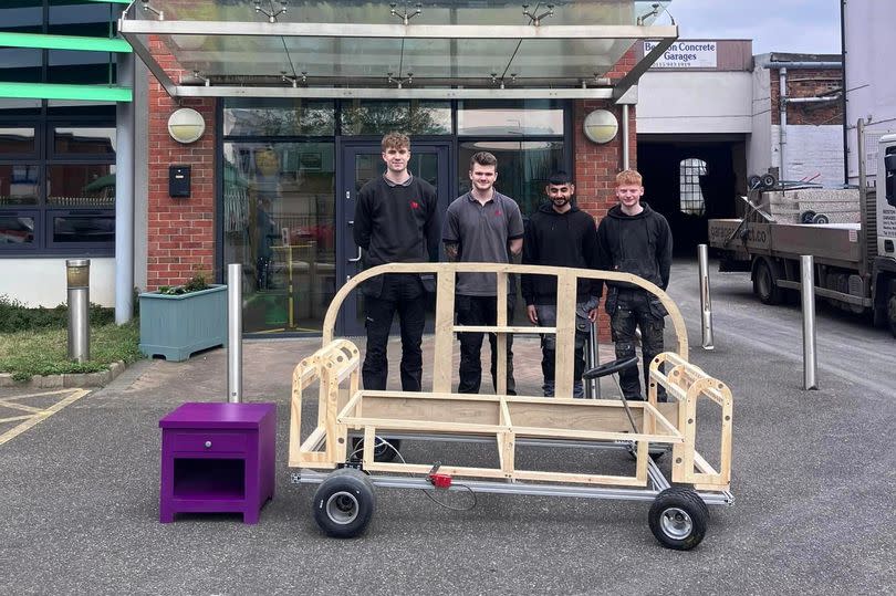 Some of the apprentices with the sofa soapbox car