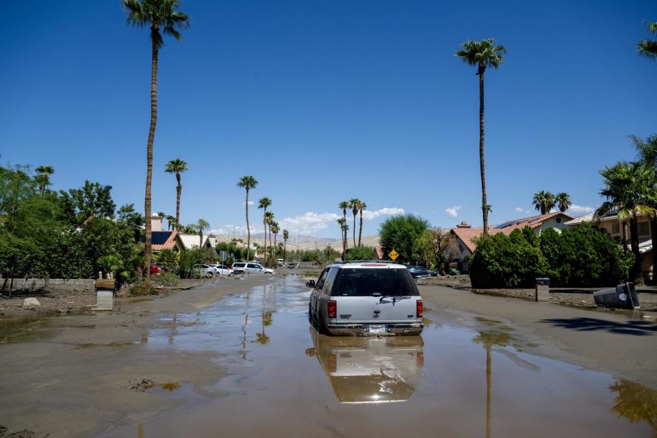 An SUV is one of many vehicles stuck in the mud