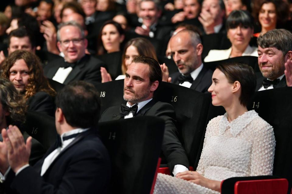 <p>Phoenix and Mara made their first public appearance as a couple at the closing ceremonies for the <a href="https://www.eonline.com/news/857734/rooney-mara-and-joaquin-phoenix-casually-make-their-awards-show-debut-at-cannes-film-festival-s-closing-night" rel="nofollow noopener" target="_blank" data-ylk="slk:Cannes Film Festival;elm:context_link;itc:0;sec:content-canvas" class="link ">Cannes Film Festival</a> on May 28, 2017. The pair sat together and interacted like a couple, including holding hands and embracing after Phoenix won the festival's best actor award for his role in 2017's <em>You Were Never Really Here</em>.</p> <p>"They were talking to one another nonstop," a <a href="https://people.com/movies/joaquin-phoenix-looked-up-fiancee-rooney-mara-internet/" rel="nofollow noopener" target="_blank" data-ylk="slk:source told PEOPLE;elm:context_link;itc:0;sec:content-canvas" class="link ">source told PEOPLE</a> at the time. "Small talk between them. Then they went for their car, and he's holding her hand like it was unconscious. Like it fits. They seem a totally natural and easy couple."</p>