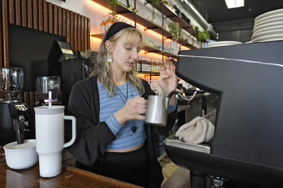 FILE - Samantha Grimison makes a cup of coffee at the Blind Tiger Cafe on Jan. 10, 2024, in Tampa, Fla. On Friday, June 5, 2024, the U.S. government issues its June jobs report. (AP Photo/Chris O'Meara, File)