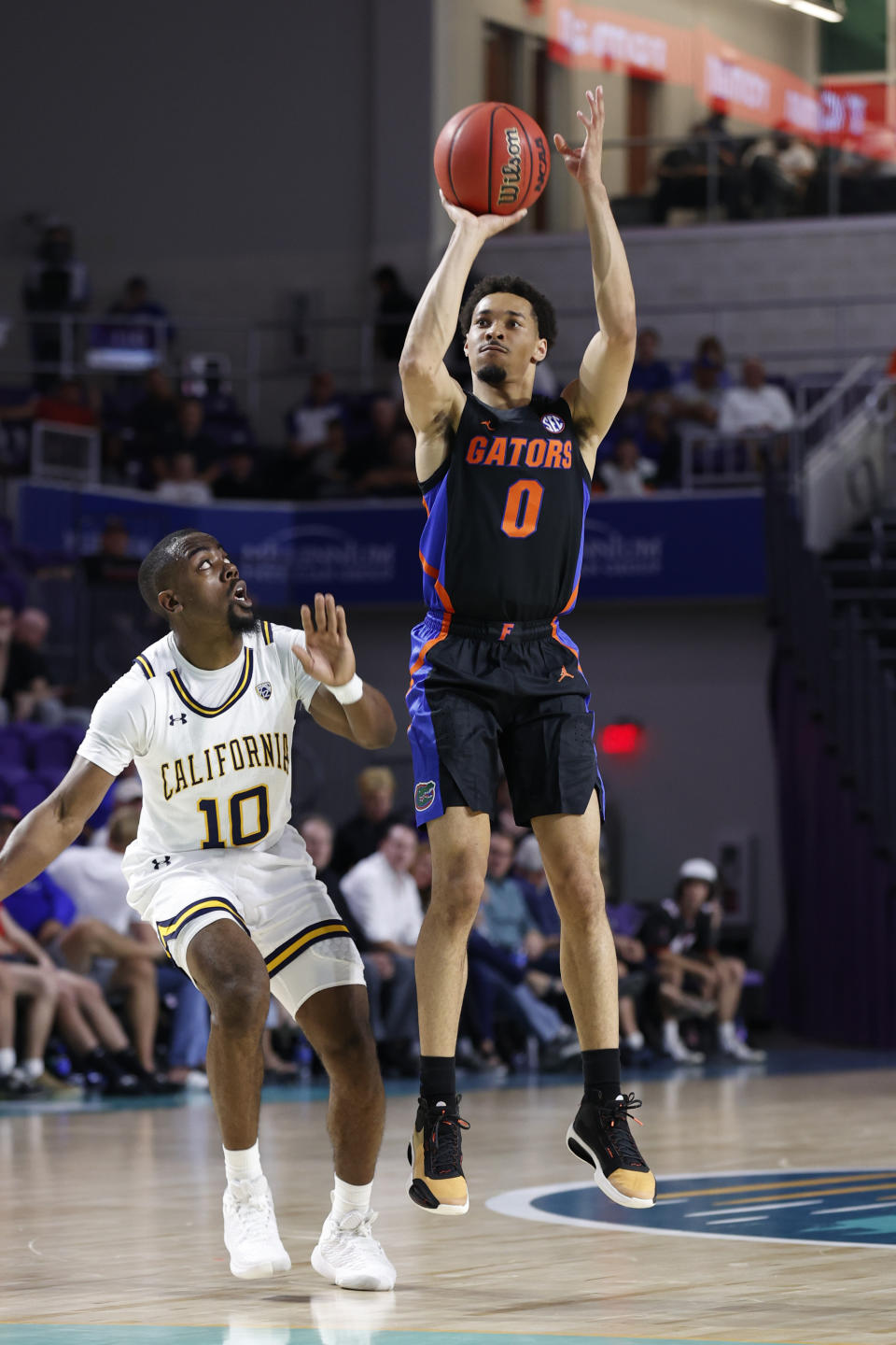 Florida guard Myreon Jones (0) shoots over California guard Makale Foreman (10) during the first half of an NCAA college basketball game Monday, Nov. 22, 2021, in Fort Myers, Fla. (AP Photo/Scott Audette)