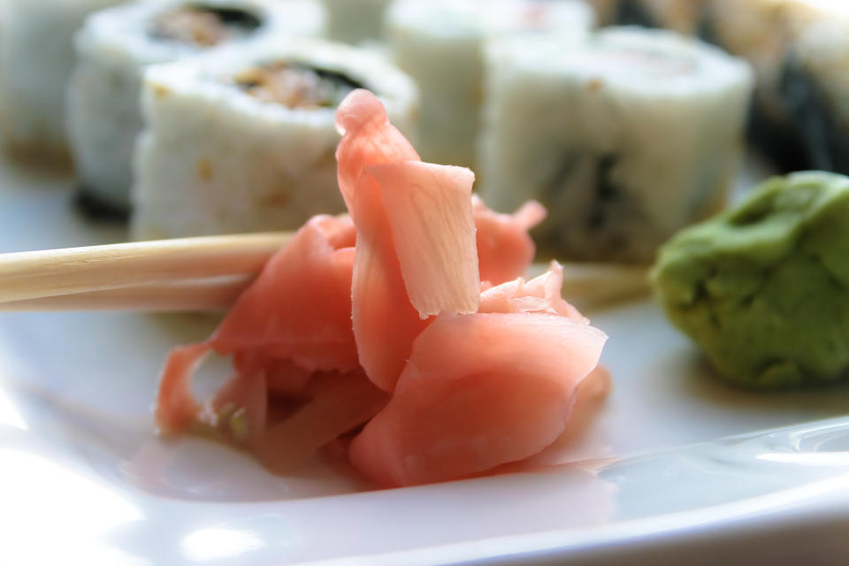 Sushi platter with wooden chopsticks, ginger and wasabi.