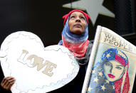 <p>Zee Arenas, of Maryland, stood for hours on a post above the crowd holding signs at the Women’s March in Washington in Washington D.C., on Saturday, Jan. 21, 2017. (Renee Jones Schneider /Star Tribune via AP) </p>