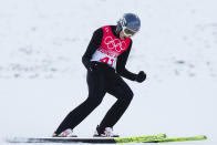 Jarl Magnus Riiber, of Norway, celebrates after his jump during the competition round of the individual Gundersen large hill/10km, ski jumping competition at the 2022 Winter Olympics, Tuesday, Feb. 15, 2022, in Zhangjiakou, China. (AP Photo/Matthias Schrader)