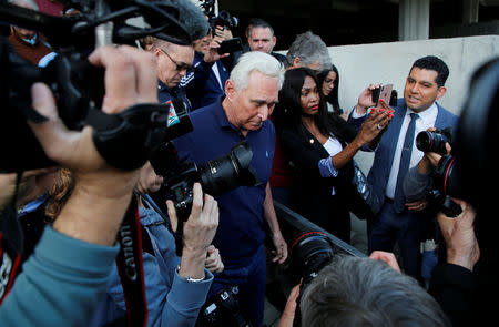 Roger Stone is surrounded by photographers as he is leaving following his appearance at Federal Court in Fort Lauderdale, Florida, U.S., January 25, 2019. REUTERS/Joe Skipper