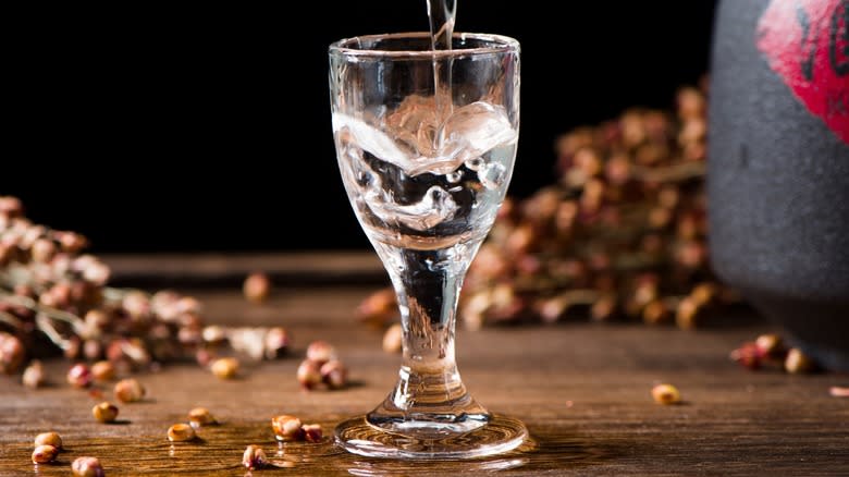 A glass of baijiu being poured