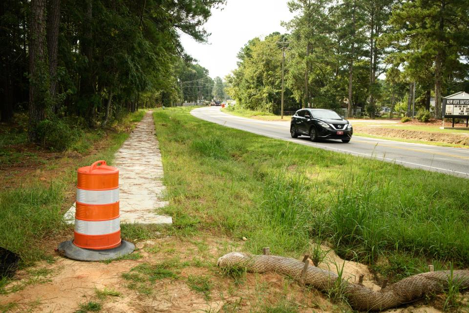 The contractor was supposed to install sidewalk, drainage pipes and bus stop pads.