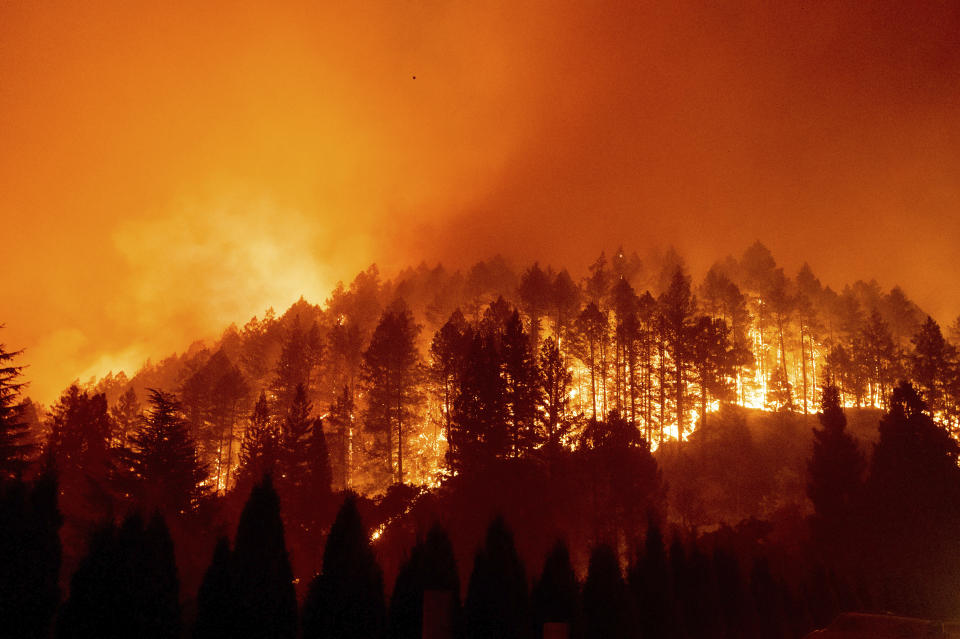 The Glass Fire burns a hillside above Silverado Trail in St. Helena, Calif., on Sunday, Sept. 27, 2020. (AP Photo/Noah Berger)