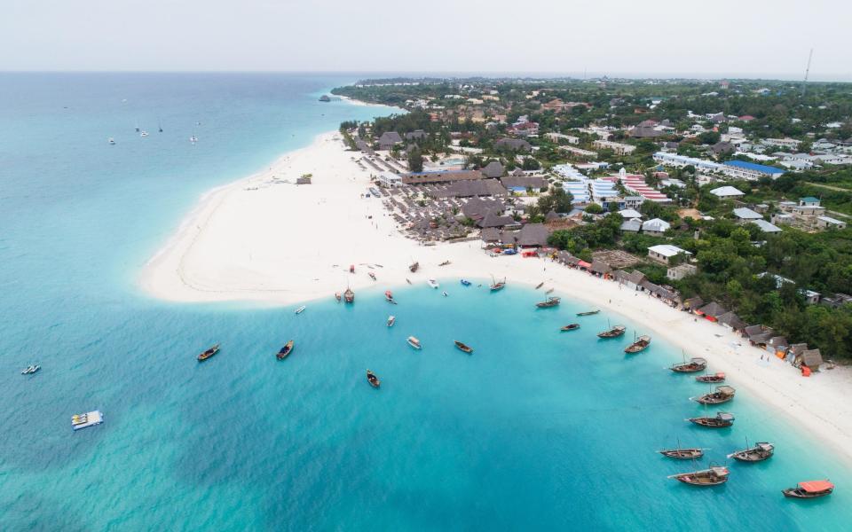 Aerial view of tropical beach with wooden fishing boats, Zanzibar island