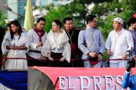 The casts of the MMFF 2012 entry "El Presidente" are seen as their float makes its way through the crowd at the 2012 Metro Manila Film Festival Parade of Stars on 23 December 2012. (L-R) Alicia Mayer, Cesar Montano, Cristine Reyes, Governor E.R. Ejercito, Christopher de Leon and Bayani Agbayani. (Angela Galia/NPPA Images)