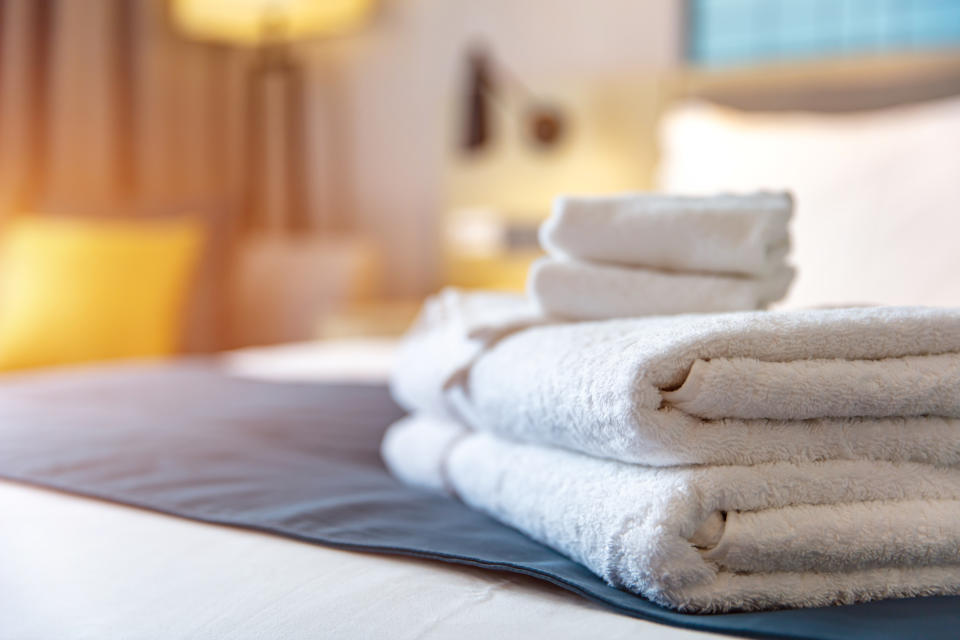 A pile of white towels on a bed