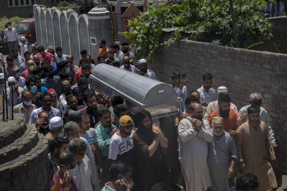 Relatives and neighbors carry the coffin of civilian Bashir Ahmed Khan during his funeral on the outskirts of Srinagar, Indian controlled Kashmir, Wednesday, July 1, 2020. Suspected rebels attacked paramilitary soldiers in the Indian portion of Kashmir, killing Khan and a paramilitary soldier, according to government sources. The family refutes the claim. (AP Photo/ Dar Yasin)