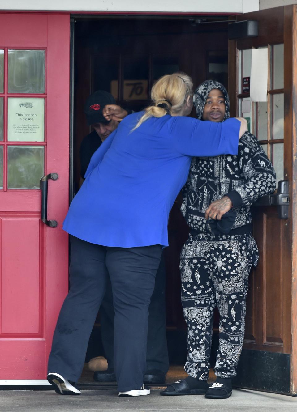 Red Lobster employees greet each other as they arrived at the 7820 Baymeadows Road location Tuesday morning to help clean out the restaurant, one of three Red Lobsters in Jacksonville that were abruptly closed Monday.