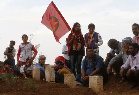 Kurds attend the funeral of the four Kurdish women fighters killed during clashes against Islamic State fighters in Kobani, at a cemetery in the southeastern town of Suruc, Sanliurfa province, October 14, 2014. REUTERS/Umit Bektas