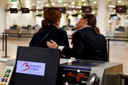 A member of the staff hugs her colleague after a ceremony at Brussels Airport as the departure hall reopens 40 days after deadly attacks, in Zaventem, Belgium, May 1, 2016. REUTERS/Eric Vidal