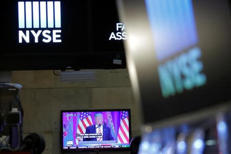 U.S. President-elect Donald Trump is broadcast on a screen on the floor at the New York Stock Exchange (NYSE) in Manhattan, New York City, U.S. December 27, 2016. REUTERS/Andrew Kelly
